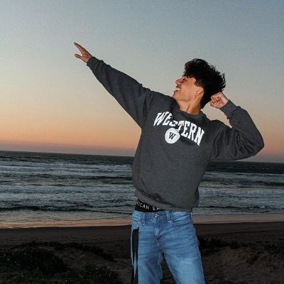 Max Torina is doing the Usain Bolt signature pose in the picture.